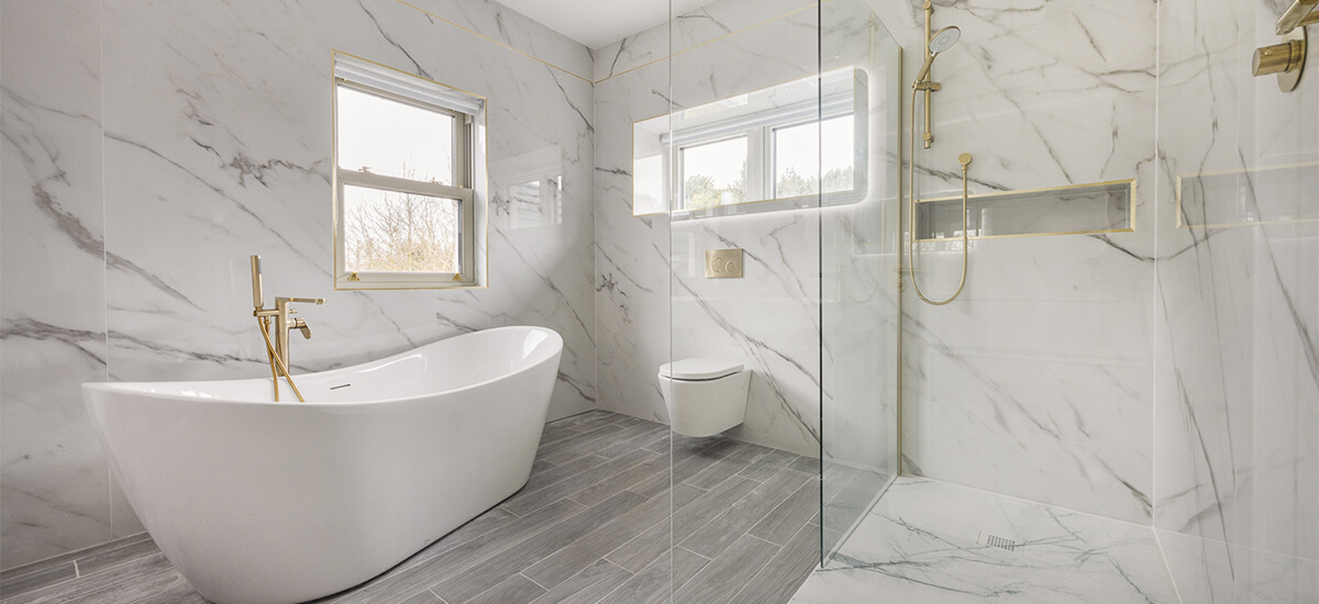 Open-plan wet room bathroom design featuring marble tiles and walk-in shower.