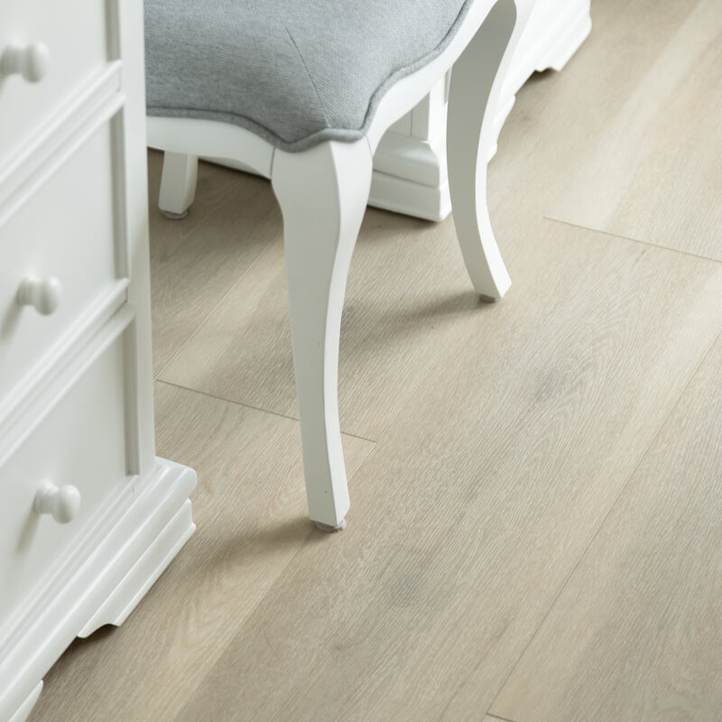 Close-up of SPC vinyl flooring with a modern chair in an Irish home.