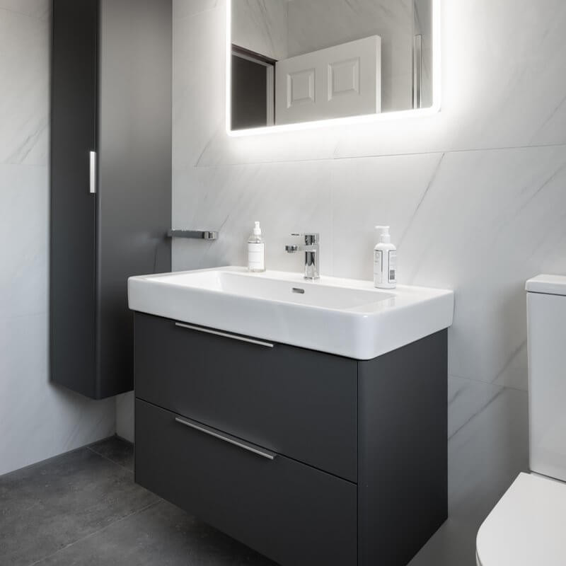 mall bathroom with contrasting wall and floor tiles