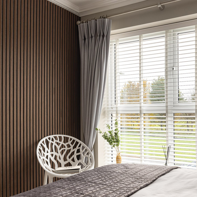 Whitewashed wooden wall planks featuring a sleek horizontal design, brightening a contemporary living space. Wall panel idea for bedroom.