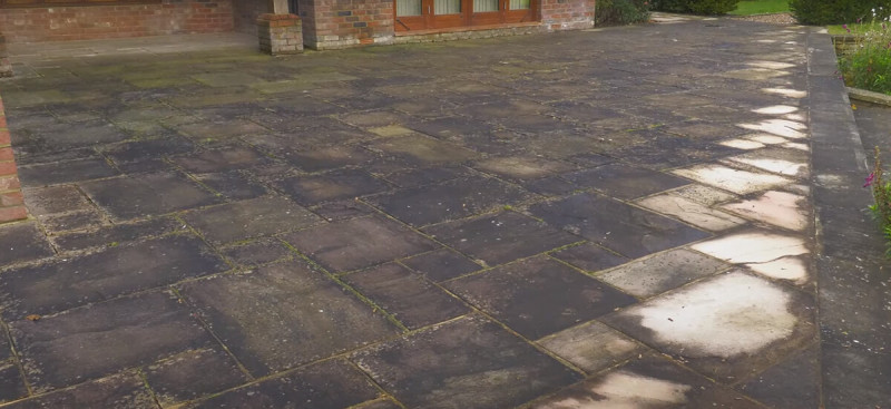  You can get rid of green algae on patio surfaces by applying a dedicated algae remover and allowing it to "dwell" for 24 hours. This chemical process kills the algae without the need for aggressive scrubbing or high-pressure water, which can often damage