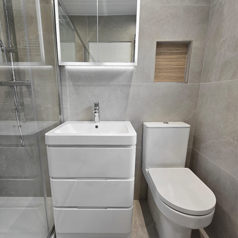 Bright small bathroom with glossy white wall tiles