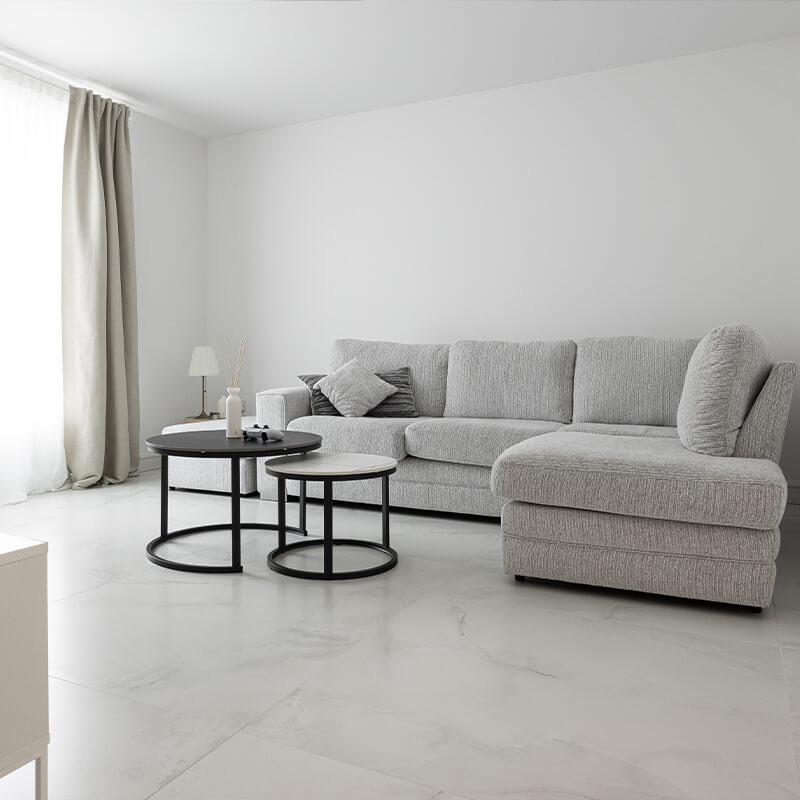 Upgrade your living room with sleek grey marble-look tiles, bringing a modern and luxurious ambiance to your home