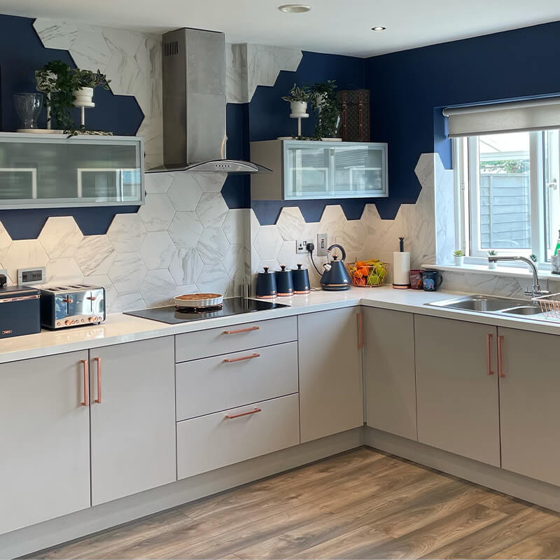 Sleek wood-effect porcelain tiles with a modern gray finish complement a contemporary kitchen design.