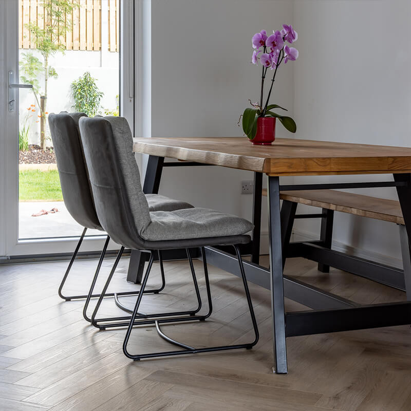 Rustic wooden kitchen table on top of SPC vinyl flooring.