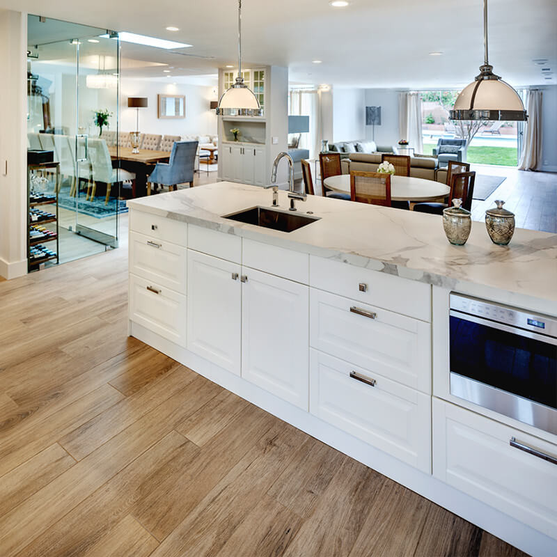 Comparing kitchen flooring options: Warm wood-effect porcelain tiles add timeless style.
