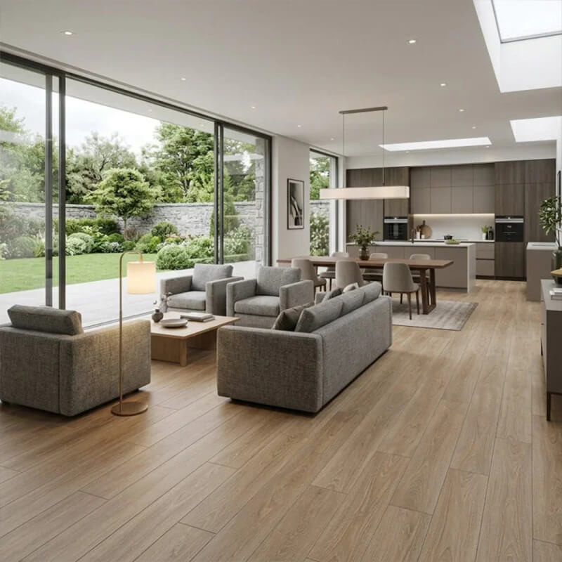 Wood-effect porcelain floor tiles Open-plan living and kitchen area with wood-effect porcelain plank floor tiles, grey sofas and glass doors to the garden