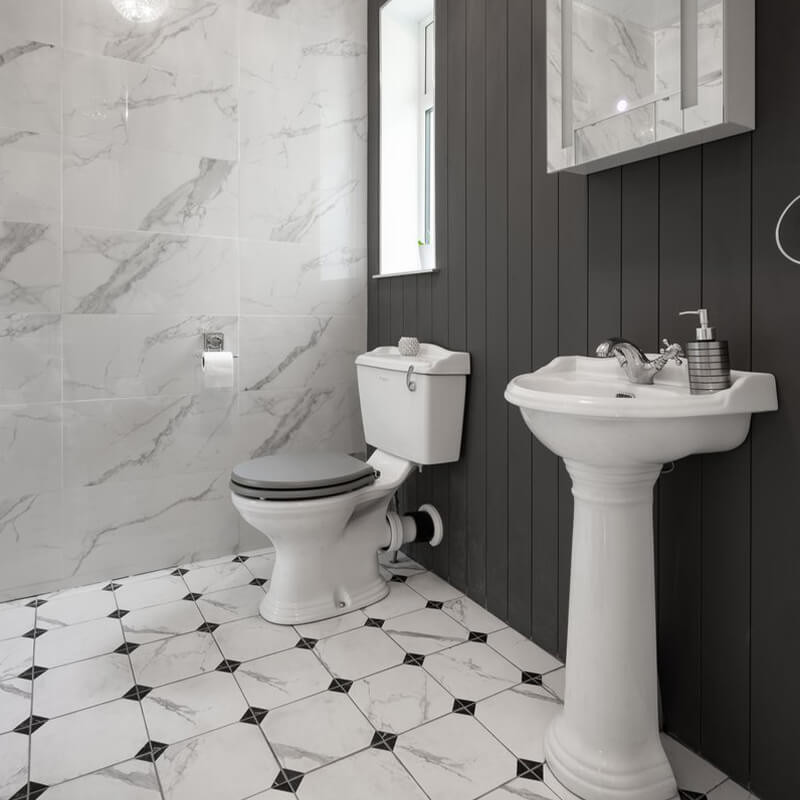 Compact bathroom with geometric tile patterns
