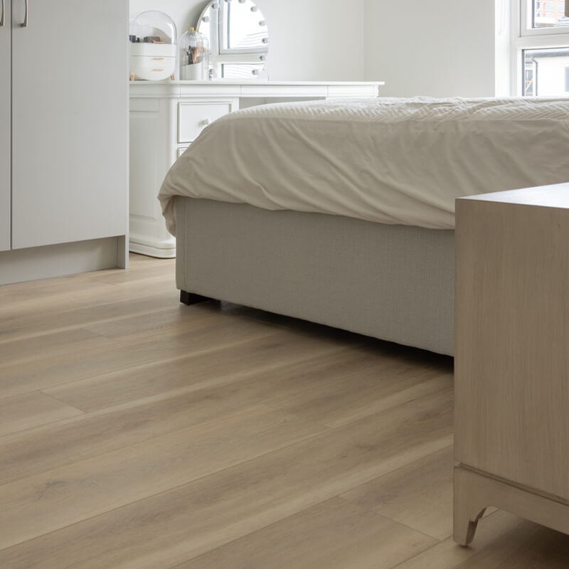 SPC vinyl flooring being installed in a contemporary Irish bedroom.