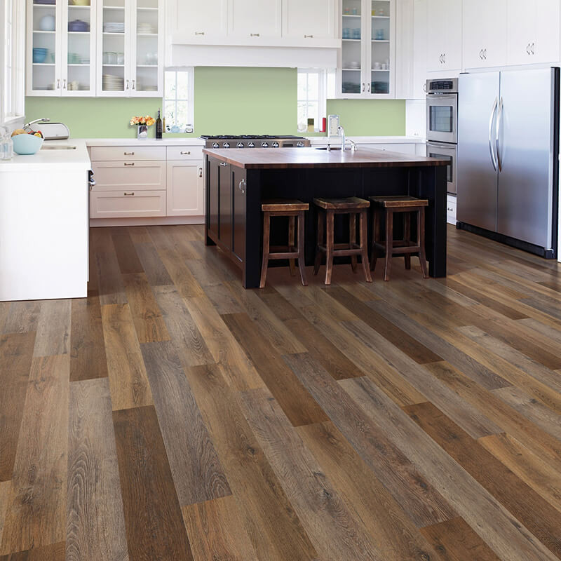 Luxurious SPC vinyl planks in a herringbone pattern create a sophisticated look in a contemporary kitchen.