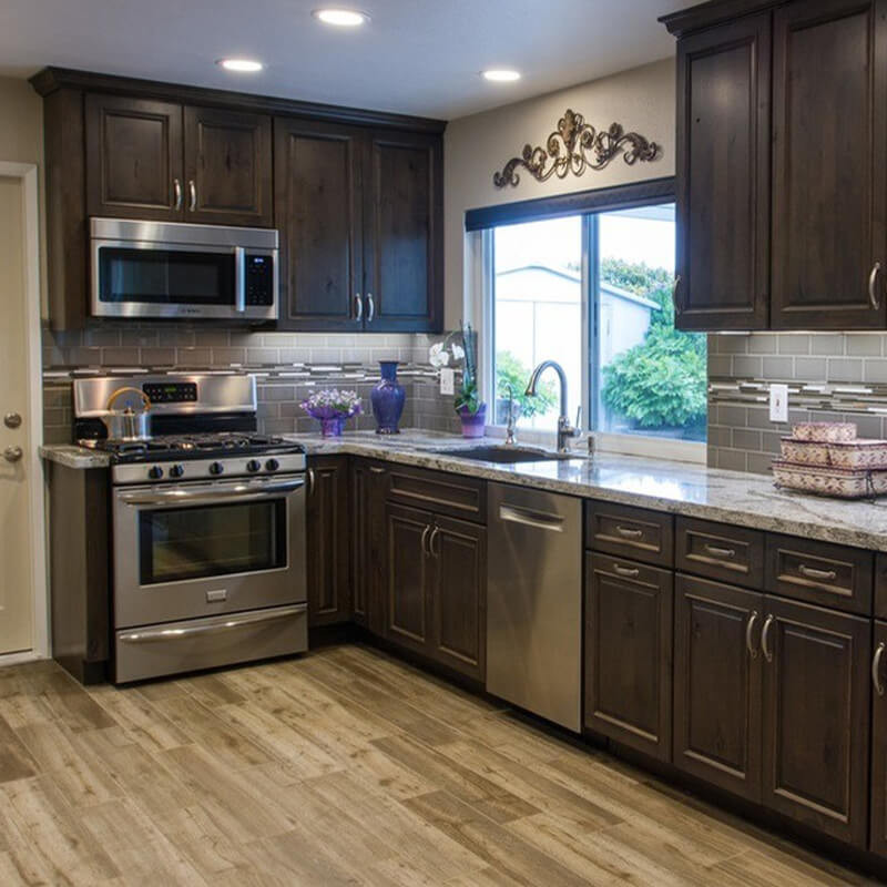 Laminate wood floor in a modern kitchen with warm gray tones.