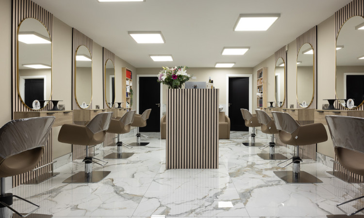 A luxury marble hair salon in Swords, Dublin, featuring Bianco Platino porcelain floor tiles and Cool Oak slatted acoustic wall panels for a modern shop fit-out.