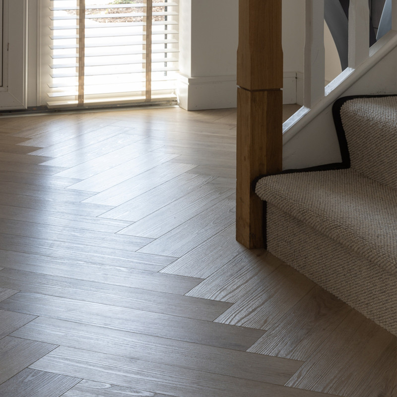 Herringbone SPC flooring in a modern home with natural light