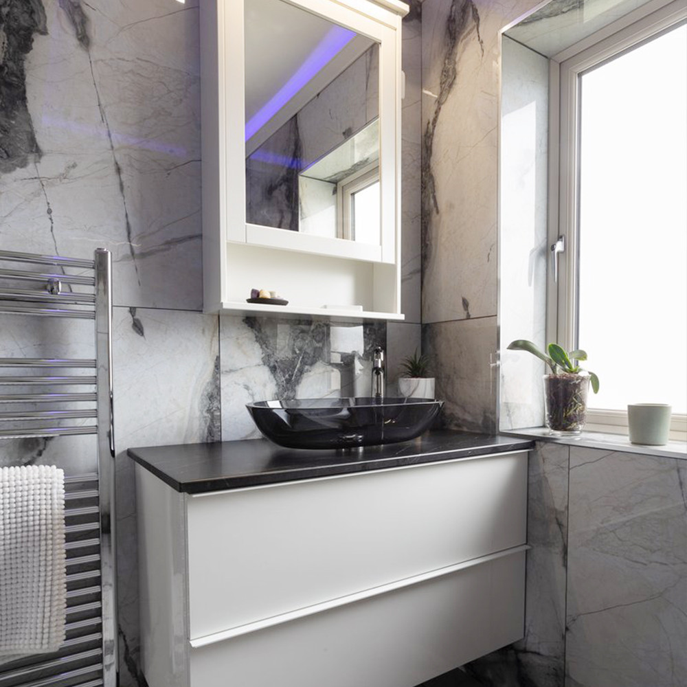 Bathroom renovation by installing large bathroom tiles on both the floor and walls of their shower room.